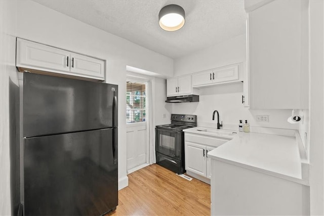 kitchen featuring white cabinetry, sink, light hardwood / wood-style floors, black appliances, and a textured ceiling