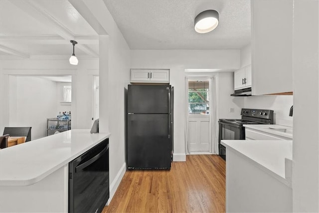 kitchen featuring white cabinetry, hanging light fixtures, black appliances, light hardwood / wood-style floors, and beverage cooler