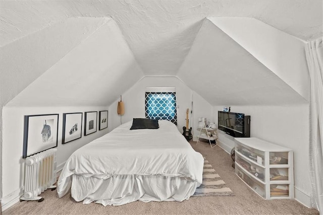 carpeted bedroom with radiator and vaulted ceiling