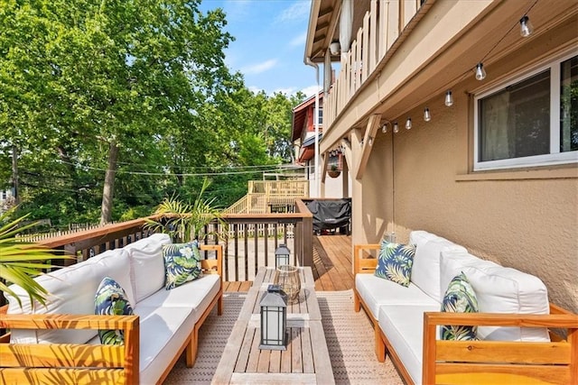 wooden terrace featuring an outdoor hangout area