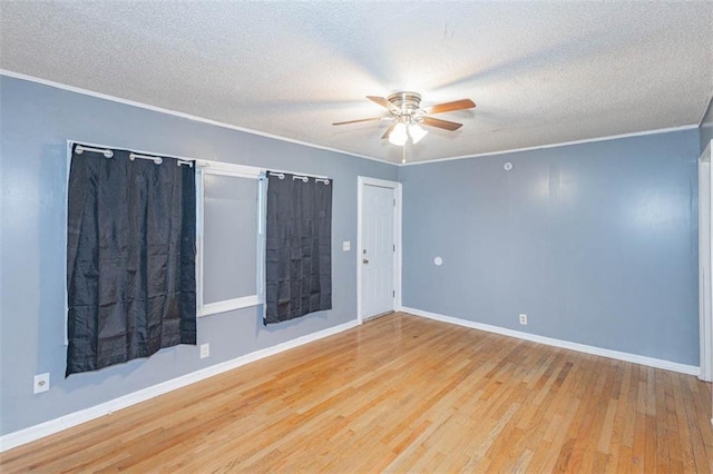 empty room featuring crown molding, ceiling fan, a textured ceiling, and light wood-type flooring