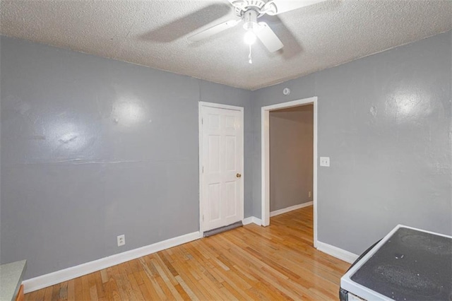 interior space featuring ceiling fan, hardwood / wood-style floors, and a textured ceiling