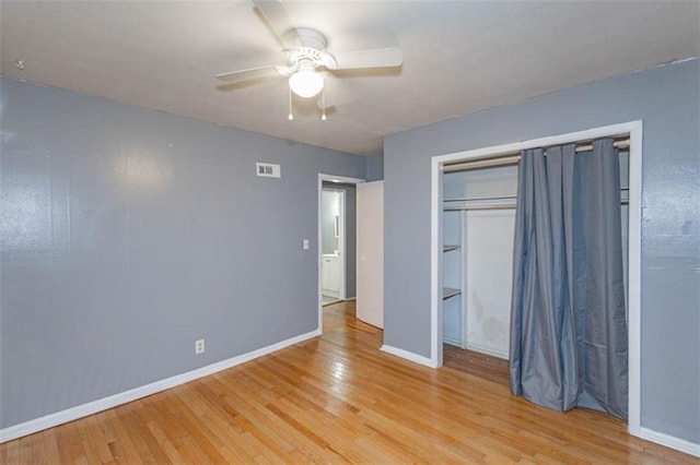 unfurnished bedroom featuring a closet, ceiling fan, and light wood-type flooring