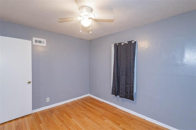 spare room with wood-type flooring and ceiling fan