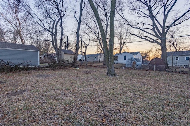 view of yard at dusk