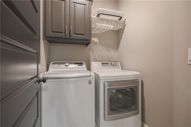 washroom with cabinets and independent washer and dryer