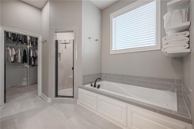 bathroom featuring tile patterned flooring and separate shower and tub