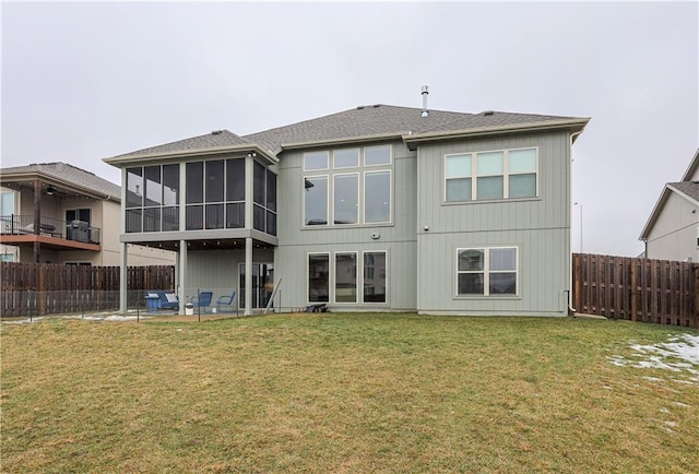 rear view of house featuring a yard, a patio area, and a sunroom