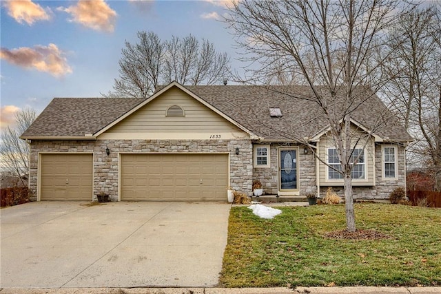 view of front of home with a yard and a garage