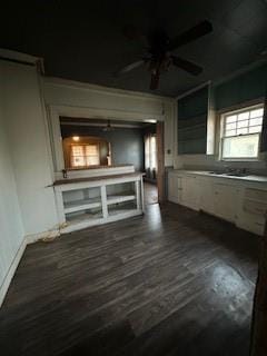 unfurnished living room featuring ceiling fan and dark hardwood / wood-style floors