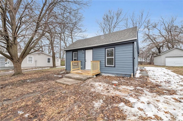 bungalow-style home with an outbuilding and a garage