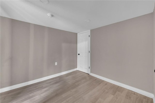 unfurnished room featuring wood finished floors and baseboards