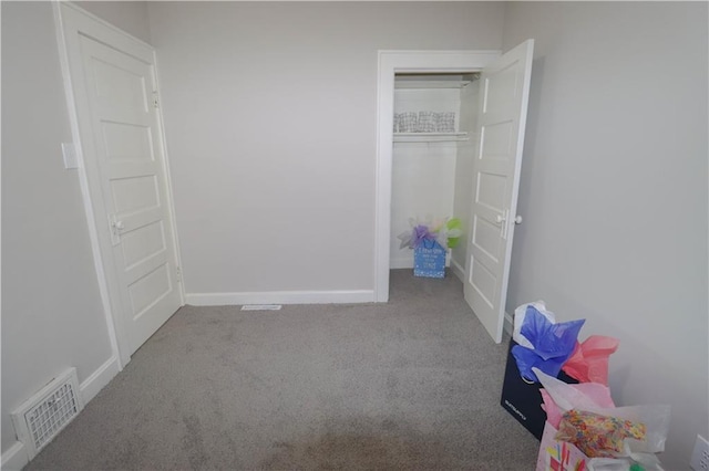 unfurnished bedroom featuring light carpet