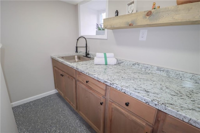 kitchen with light stone counters and sink