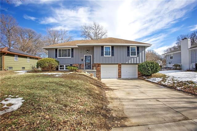 bi-level home featuring a garage and a front yard