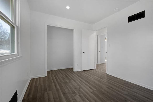 unfurnished bedroom with dark hardwood / wood-style floors