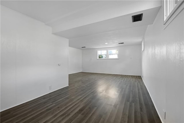 basement with dark hardwood / wood-style floors