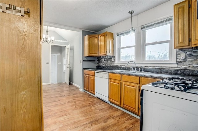 kitchen featuring sink, tasteful backsplash, light wood-type flooring, pendant lighting, and white appliances