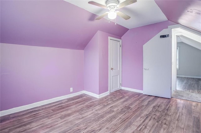 bonus room with lofted ceiling, light hardwood / wood-style floors, and ceiling fan