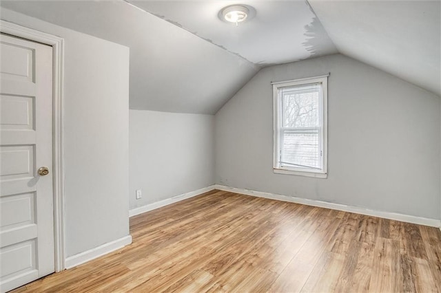 bonus room with vaulted ceiling and light hardwood / wood-style floors