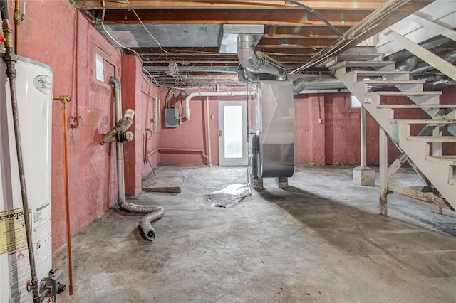 basement featuring heating unit, electric panel, and water heater