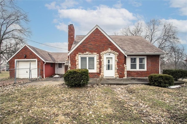 view of front of home with a garage and a front lawn