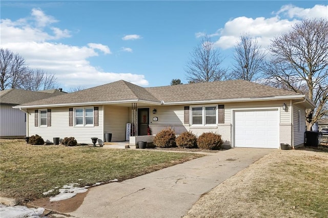 ranch-style home featuring a garage and a front lawn