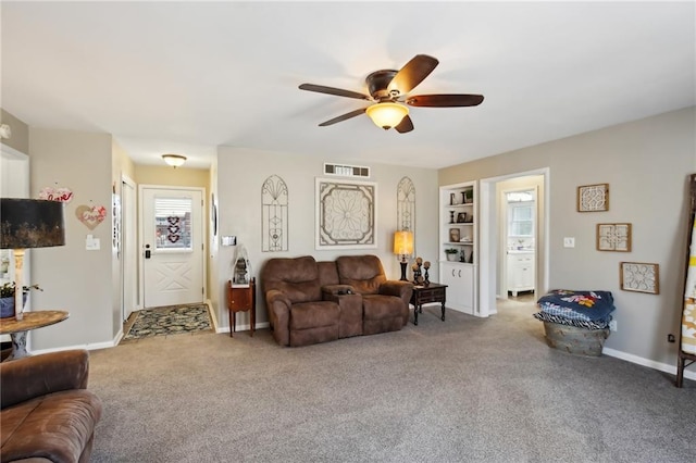 carpeted living room featuring ceiling fan