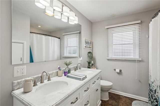 bathroom featuring vanity, toilet, and tile patterned flooring