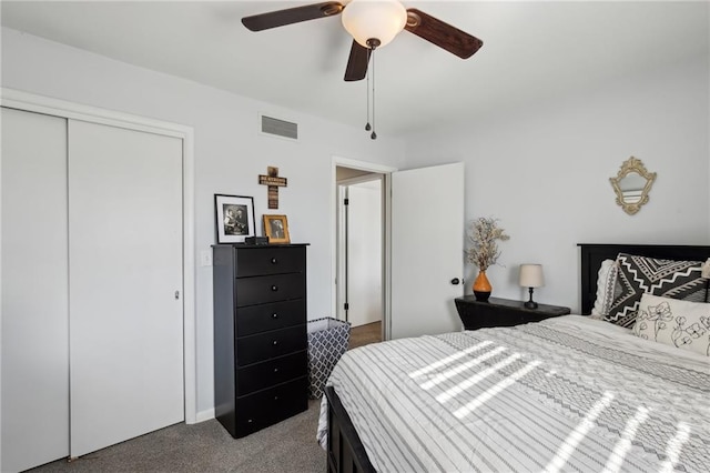 carpeted bedroom with ceiling fan and a closet