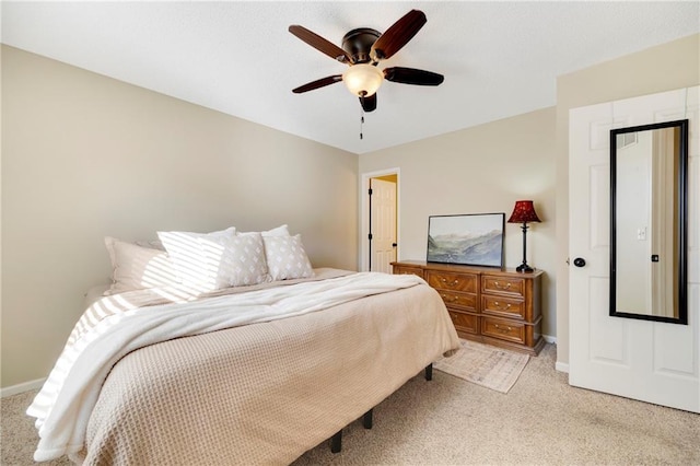 bedroom featuring light colored carpet and ceiling fan