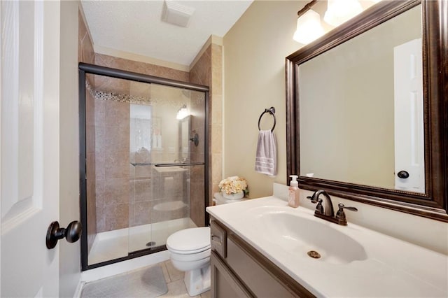 bathroom featuring vanity, toilet, a textured ceiling, and walk in shower