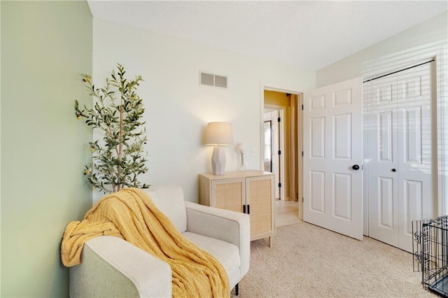 sitting room featuring light colored carpet