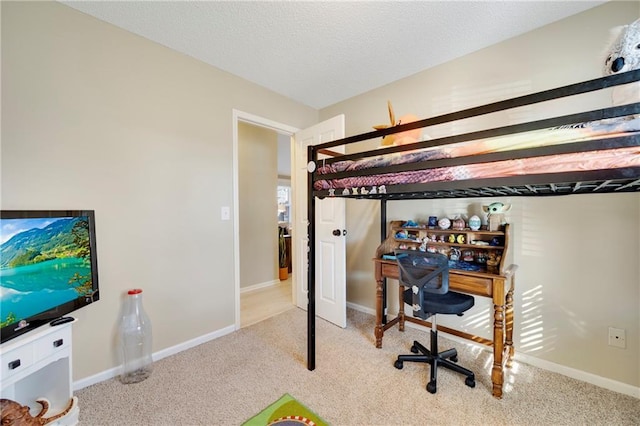 bedroom with light carpet and a textured ceiling