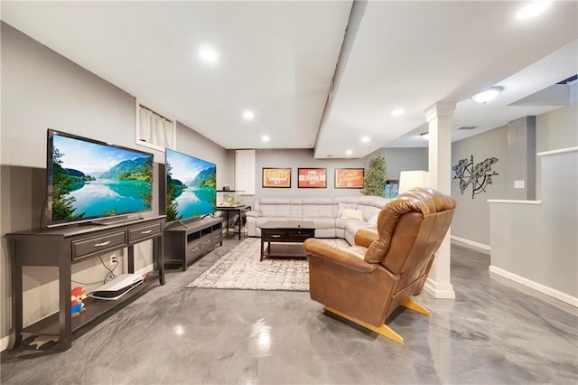 living room featuring concrete flooring and ornate columns