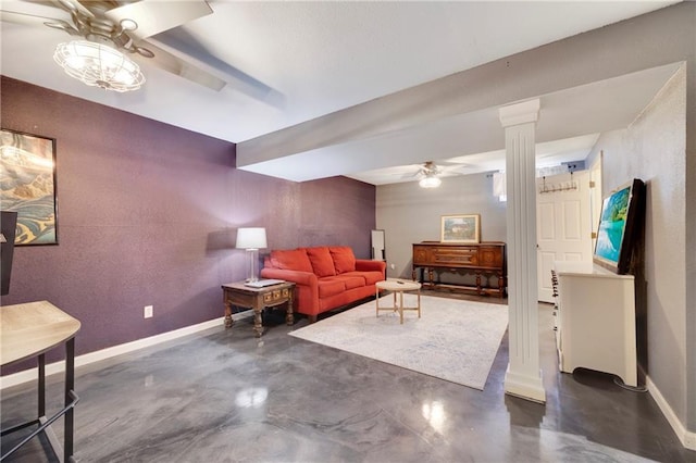 living room featuring ceiling fan and decorative columns