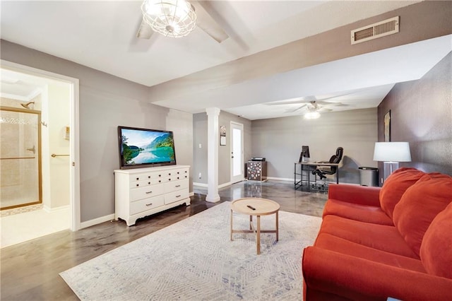 living room with ceiling fan and ornate columns