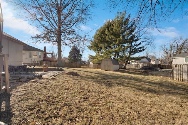 view of yard with a storage unit and a patio