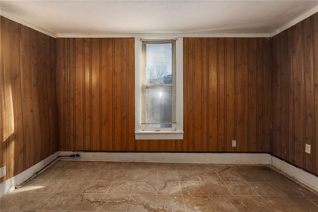 spare room featuring wood walls