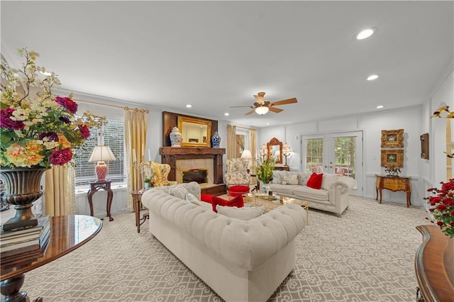 living room featuring french doors, light colored carpet, plenty of natural light, and ceiling fan