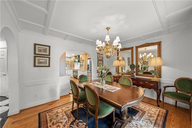 dining area with light hardwood / wood-style flooring and a chandelier