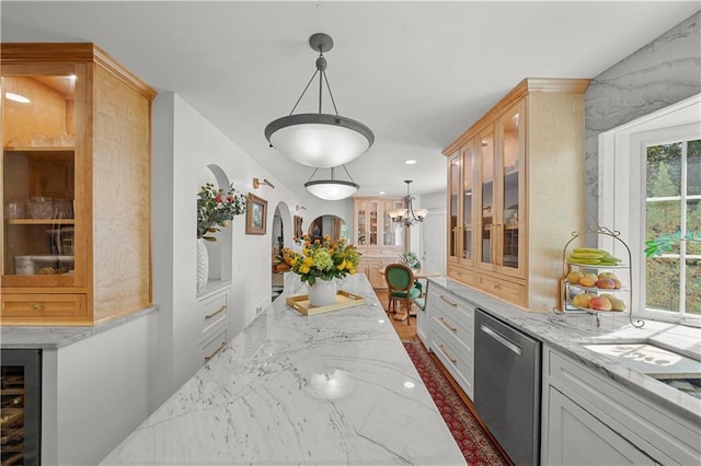 kitchen featuring wine cooler, white cabinets, hanging light fixtures, stainless steel dishwasher, and light stone counters