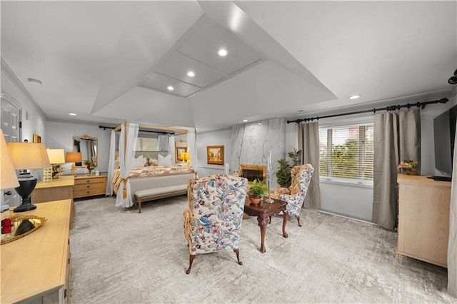 bedroom with a fireplace and light colored carpet