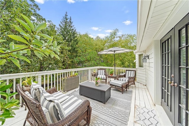 wooden terrace with an outdoor hangout area and french doors