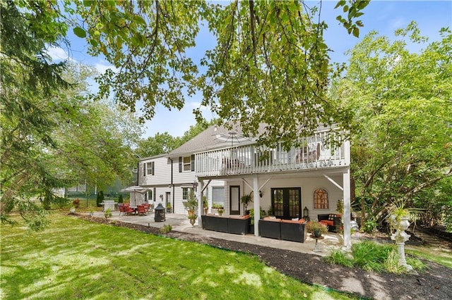 rear view of property featuring an outdoor hangout area, a yard, and a patio area