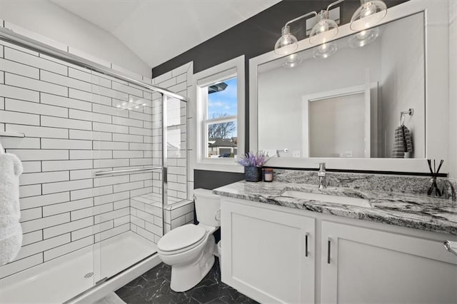 bathroom with lofted ceiling, vanity, toilet, and walk in shower