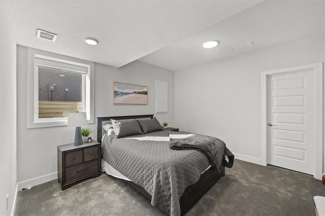 carpeted bedroom with a textured ceiling