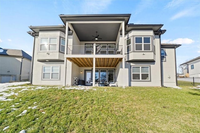 rear view of property featuring a lawn, ceiling fan, and a patio area