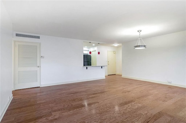 unfurnished living room with wood-type flooring