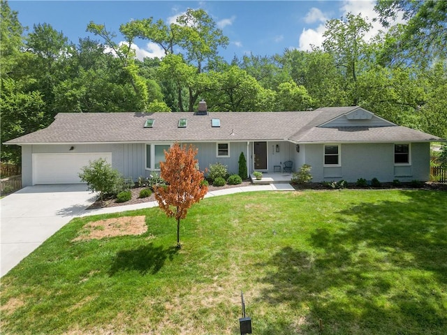 single story home with a garage and a front lawn